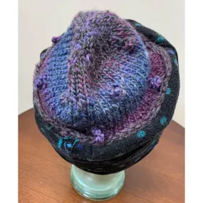 Soft cozy black and blue winter hat from repurposed and hand - knitted yarns with a silk neck tie brim.