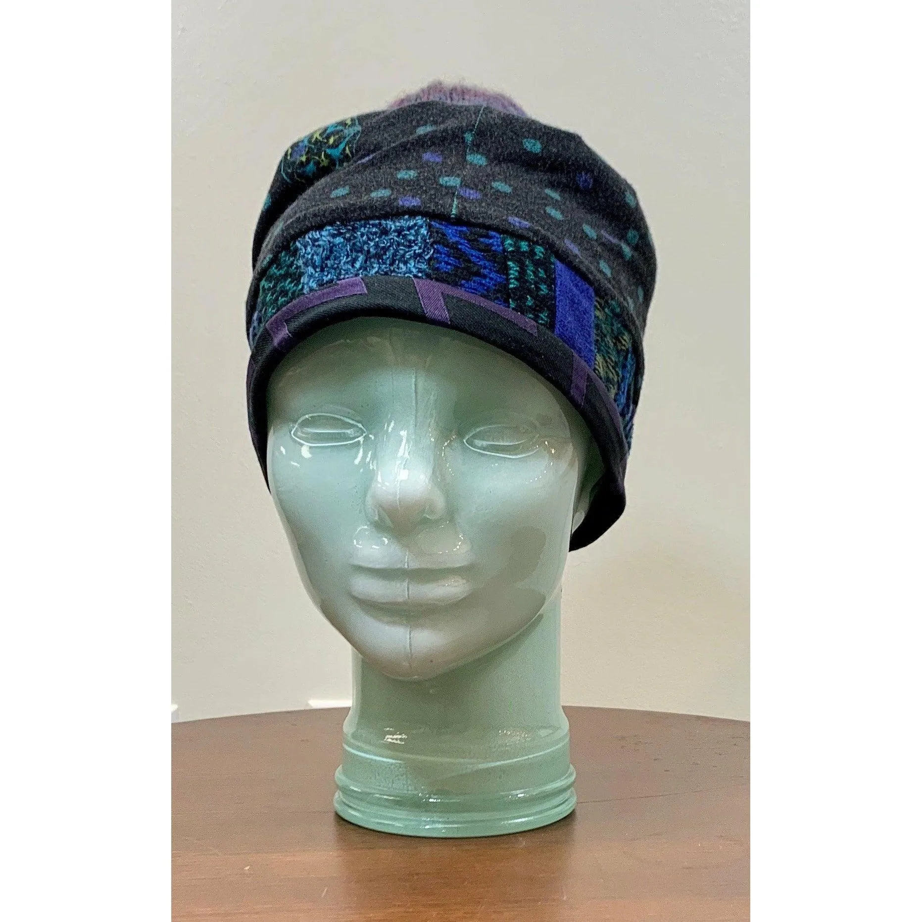 Soft cozy black and blue winter hat from repurposed and hand - knitted yarns with a silk neck tie brim.