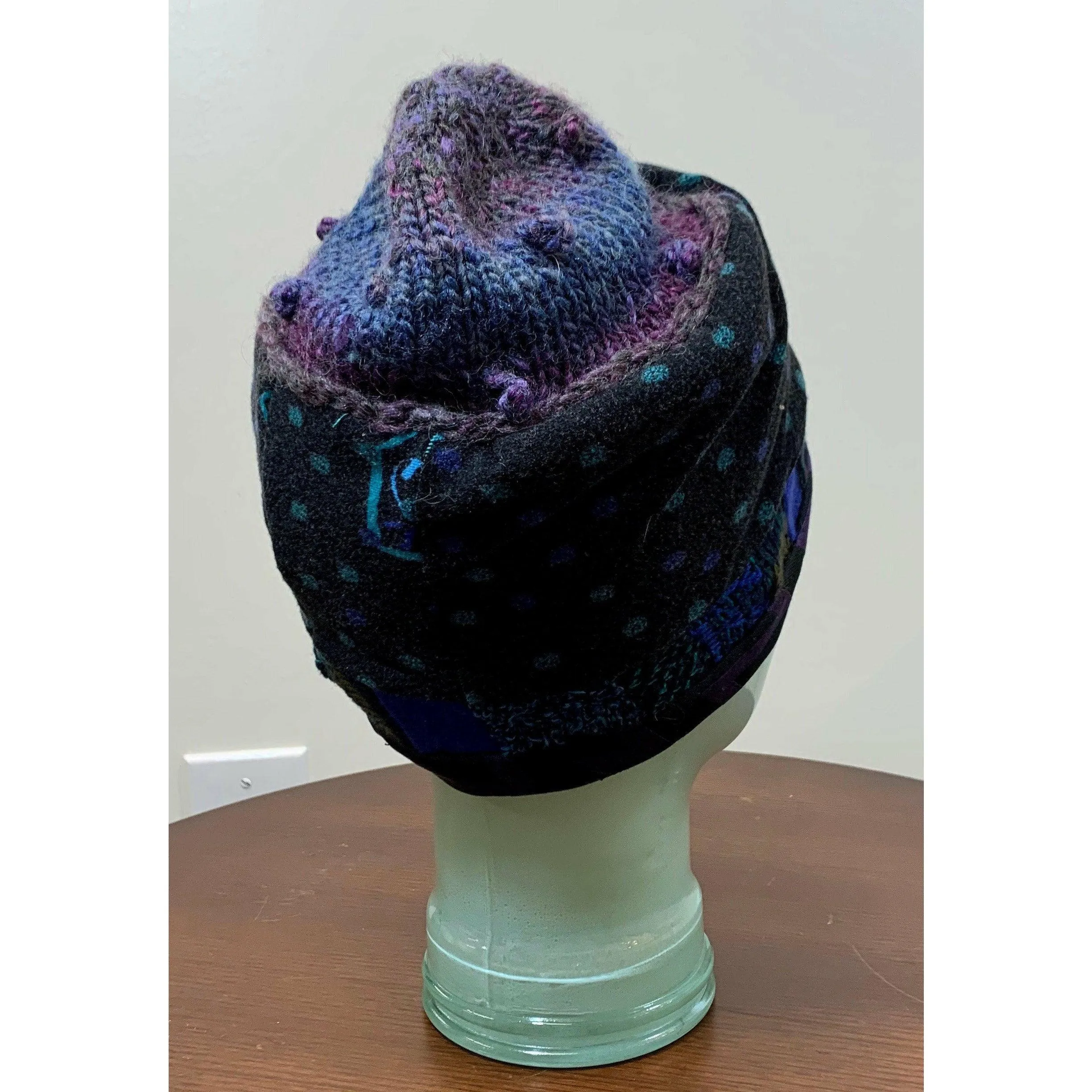 Soft cozy black and blue winter hat from repurposed and hand - knitted yarns with a silk neck tie brim.